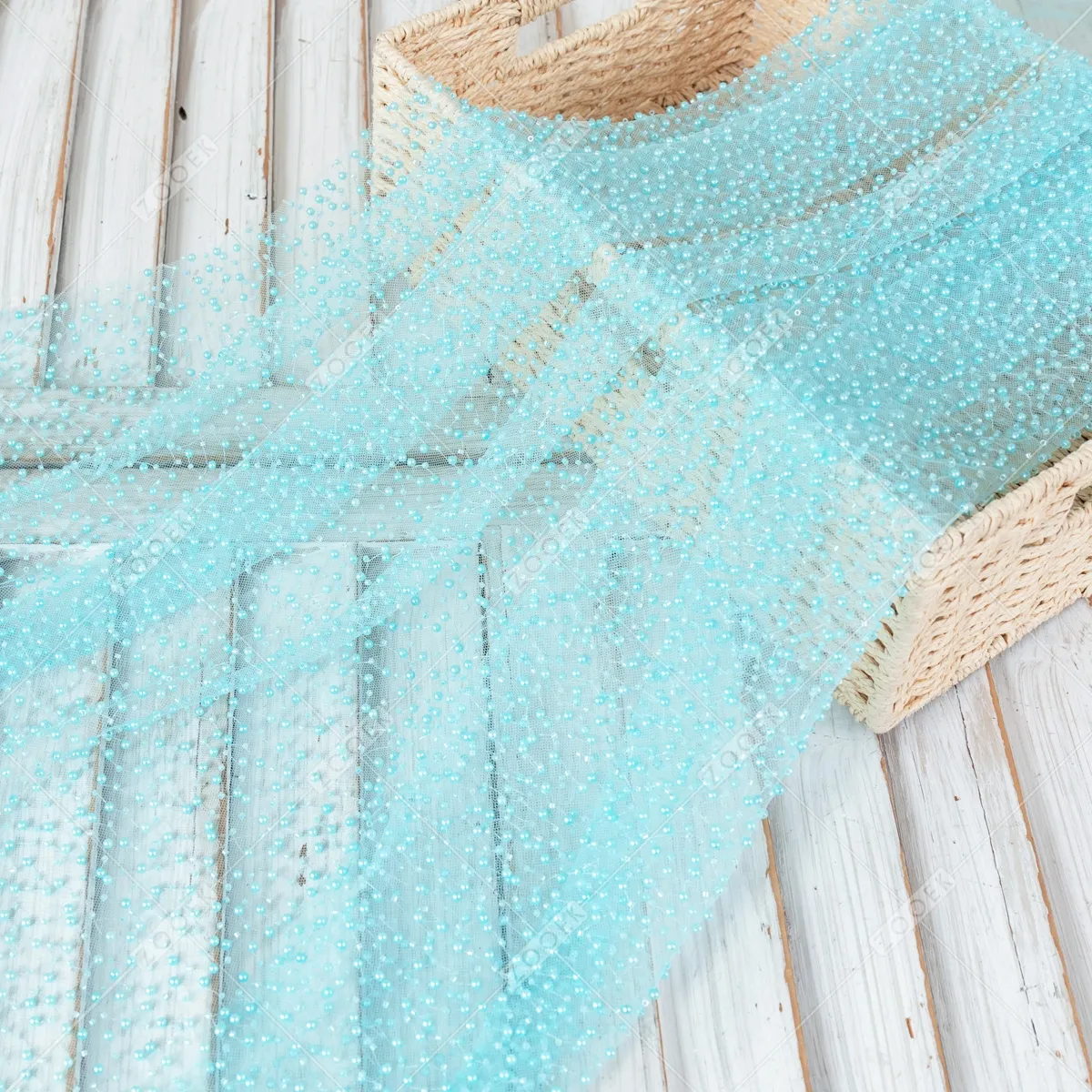 sheer Tiffany blue mesh adorned with an array of shimmering pearls sheer Tiffany blue mesh adorned with an array of shimmering pearls